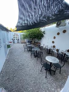 a group of tables and chairs in a patio at Hammocks - Hamacas in Ríohacha