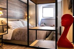 Zimmer mit einem Schlafzimmer mit einem Bett und einer Puppe in der Unterkunft La Casa dello Stilista in Brescia