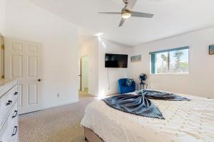 a bedroom with a bed and a flat screen tv at Catch Me By The Sea in Clearwater Beach