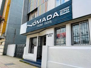 a building with a sign on the front of it at Nomada 870 - Hotel Work in Osorno