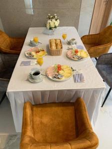 a white table with plates of food on it at Hotel Flora in Schwäbisch Gmünd