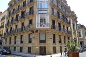 un grand bâtiment jaune au coin d'une rue dans l'établissement Talaia HT, à Saint-Sébastien