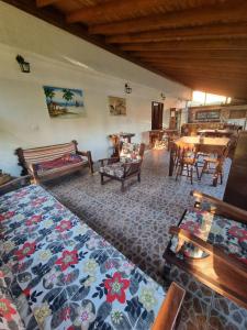 a living room filled with furniture and a table at Pousada dos Quiosques in Viamão