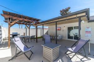 a patio with chairs and a table and a grill at New-5 Star Sunset Views l Amazing Pool -Short & Long stays l GCU in Phoenix