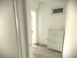 a white bathroom with a dresser and a mirror at Central apartment - Cismigiu & Izvor Park in Bucharest