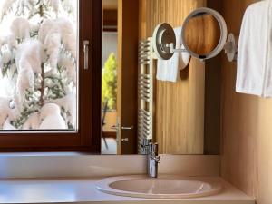 a bathroom with a sink and a mirror at Naturhaus Loacker in Lech am Arlberg