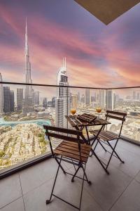 een tafel en stoelen op een balkon met uitzicht op de stad bij SmartStay at Burj Royale - Full Burj Khalifa View - Brand New Luxury Apartments in Dubai