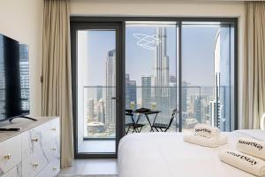 a hotel room with a view of a city at SmartStay at Burj Royale - Full Burj Khalifa View - Brand New Luxury Apartments in Dubai