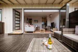 a living room with a bottle of wine on a table at Ocean Grace by the River and Ocean Pet Friendly in Ocean Grove