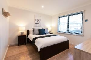 a bedroom with a large bed and a window at Ocean Grace by the River and Ocean Pet Friendly in Ocean Grove