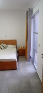 a bedroom with a bed and a large window at Apartments A&A - Santa Maria in Santa Maria