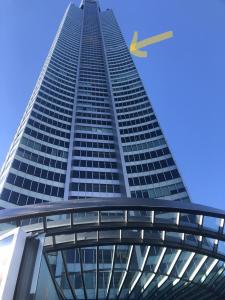 a tall building with a yellow arrow on it at Deluxe Private Apartment in Surfers Paradise in Gold Coast