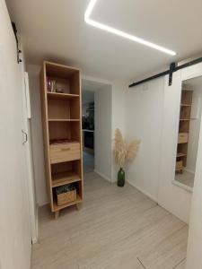 een lege kamer met een boekenplank en een hal bij Bilocale in centro storico -Le mensaline- Casa Chiricopo in Modica