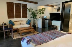 a living room with a couch and a table at Talavera Palm Springs in Palm Springs