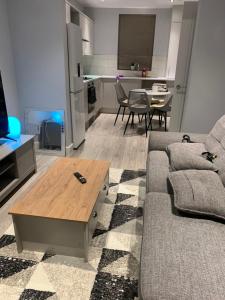 a living room with a couch and a table at stranmillis Suites in Belfast
