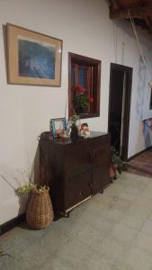 a room with a dresser and a mirror on a wall at Casa La Plazuela in Curití