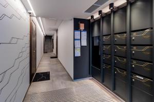 a hallway with lockers in a locker room at Cozy apartment by the Baltic Sea in Tallinn