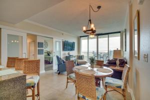 a dining room and living room with a table and chairs at Resort-Style Biloxi Condo Walk to the Beach! in Biloxi