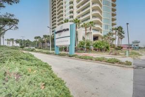 a sign on the side of a road in front of a building at Resort-Style Biloxi Condo Walk to the Beach! in Biloxi