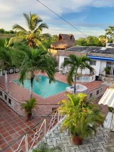 um resort com piscina e palmeiras em VILLA MARIA em Turbaco