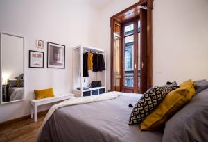 a bedroom with a large bed and a mirror at Casa Frangiò Modern Apartment Historical Centre in Naples