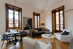 a living room with a couch and a table at Casa Frangiò Modern Apartment Historical Centre in Naples