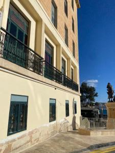 a building with a statue on the side of it at Grand Harbour View in Valletta
