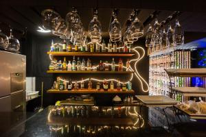 a bar with a bunch of glasses on the wall at Hotel Restaurant 1904 in Apizaco