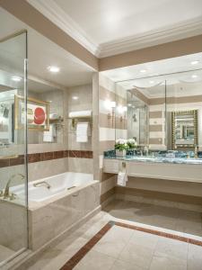 a bathroom with a tub and a large mirror at The Venetian® Resort Las Vegas in Las Vegas