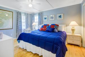 a blue bedroom with a bed with a blue comforter at Livin Is Easy in Edisto Island