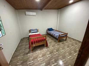 a room with two beds in a room at Apartamentos IVAGO in Encarnación