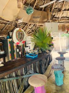 a room with a wooden table with plants on it at Casa Jade Ecobungalows Las coloradas in Yuluc