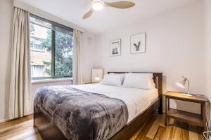 a bedroom with a large bed and a window at Tranquil Botanical - A Slice of Riverside Paradise in Melbourne