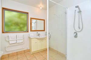 a bathroom with a sink and a shower at Watson Street - Bookahome in Akaroa