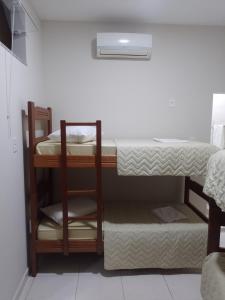 a room with two bunk beds in it at Pousada Mundo Novo in Aparecida