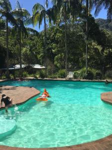 a person riding a water slide in a swimming pool at Mt Warning Rainforest Park 