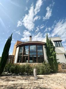 a house with a large window on top of it at Villa Mirador in Manzanera