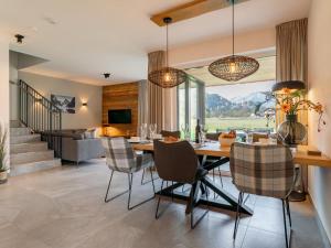 a dining room and living room with a table and chairs at Mountain Chalet Chapeau in Sankt Lorenzen ob Murau