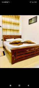 a bedroom with a bed with two pillows on it at Transit house in Katunayake