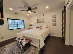 a bedroom with a bed with a ceiling fan at Grand Wood Suites in Nashville