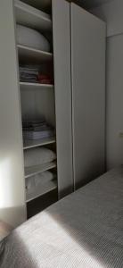 a bedroom with a bed and a closet at Modern Apartment with great terasse and mountain view in Braşov
