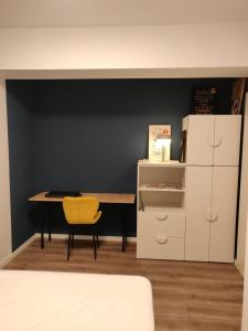 a room with a table and a yellow chair at Modern Apartment with great terasse and mountain view in Braşov