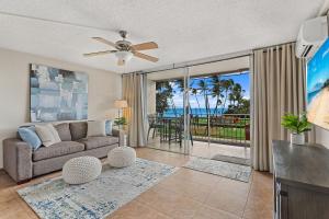a living room with a couch and a view of the ocean at Island Surf 304 - Renovated, Ocean Views, Split AC in Kihei