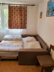 two beds in a room with a window at Apartments for families with children Delnice, Gorski kotar - 21746 in Delnice