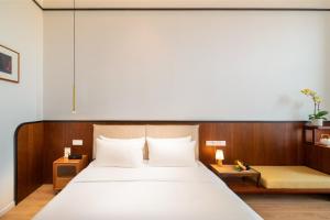 Posteľ alebo postele v izbe v ubytovaní Wuyu Hotel, Smart Park & Happy Valley Jinshansi Metro