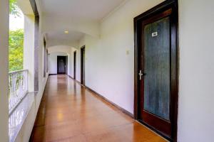 a hallway with a wooden door in a building at Martins Inn in Arnālapāda