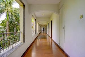 an empty corridor of a building with a hallway with a balcony at Martins Inn in Arnālapāda