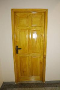 a wooden door in the corner of a room at Lone Star Residence in Jaffna