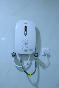 a wii controller with a stethoscope hanging from a wall at Lone Star Residence in Jaffna
