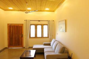 a living room with a couch and a table at Lone Star Residence in Jaffna